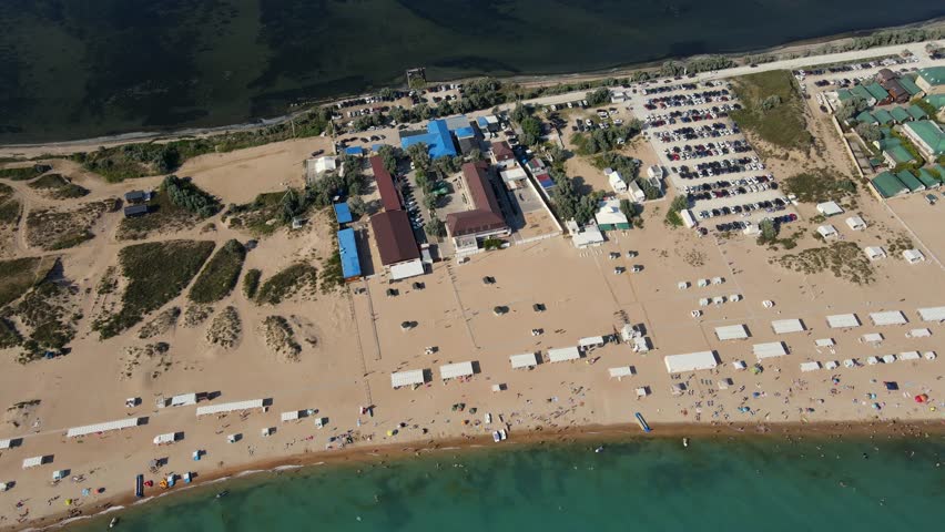 Aerial view of Bugaz Spit and Black Sea shoreline in summer, showing hotels, parking lots, and beach infrastructure. Krasnodar Krai, Blagoveshchenskaya, Anapa
