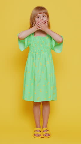 Young blonde child girl kid pointing with fingers at copy space below for advertising, like, subscribe, follow in social media app, recommend proposal announcement. Little preteen children. Vertical