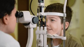 Young boy undergoing slit lamp eye exam by optometrist - Powered by Shutterstock - Get 15% off with code: PIKWIZARD15