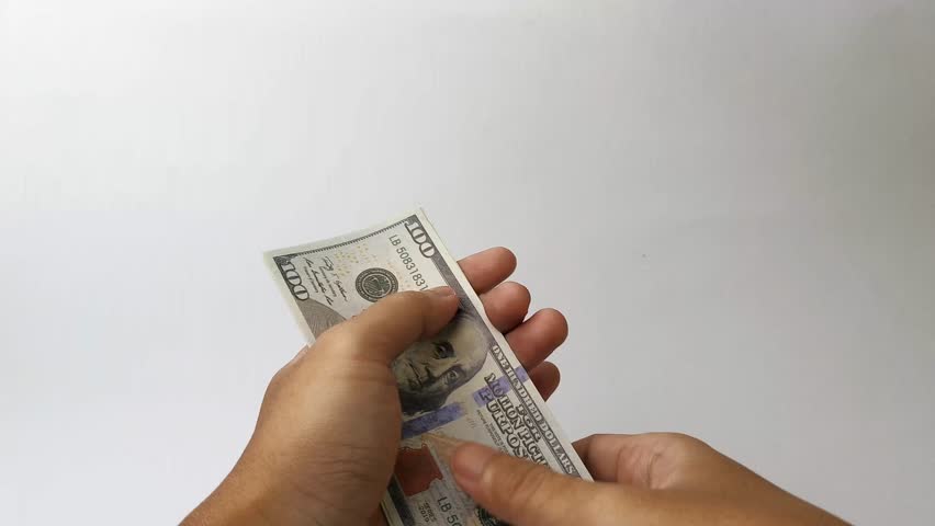 man counting a bunch of hundred dollar bills isolated on white background