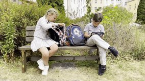 Schoolchildren check backpacks in school garden - Powered by Shutterstock - Get 15% off with code: PIKWIZARD15