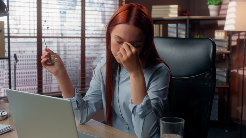 Caucasian girl business woman female worker businesswoman employer in office working laptop tired computer overworked eyes discomfort pressure take off glasses touch nose bridge headache pain stress