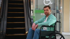 Confident businessman in wheelchair communicating near escalator - Powered by Shutterstock - Get 15% off with code: PIKWIZARD15