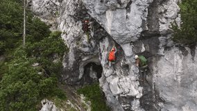 Group of climbers on a route, on a rock with belay via ferrata. Drone view of people in equipment - Powered by Shutterstock - Get 15% off with code: PIKWIZARD15
