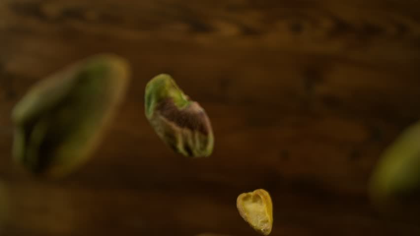 Super Slow Motion Shot of Peeled Pistachio Nuts Falling Around Camera at 1000fps.