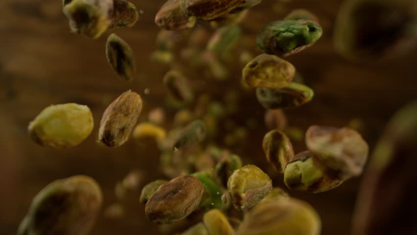 Super Slow Motion Shot of Peeled Pistachio Nuts Falling Around Camera at 1000fps.