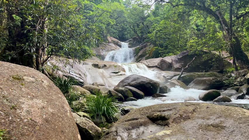 Relaxing scene of water flowing over rocks at Josephine Falls, Queensland, Australia