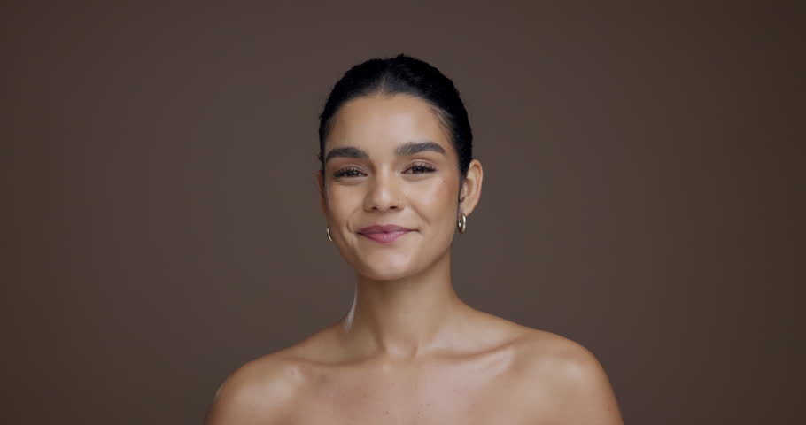 Face, confident and woman with smooth skin, beauty and bodycare with treatment for glow or cosmetic. Studio background, self care and person with pride for skincare, mockup space and dermatology