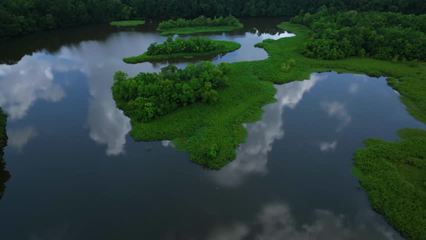 Peaceful nature outdoor green space and calm lake with cloud reflections Crystal Lake Jackson, Mississippi