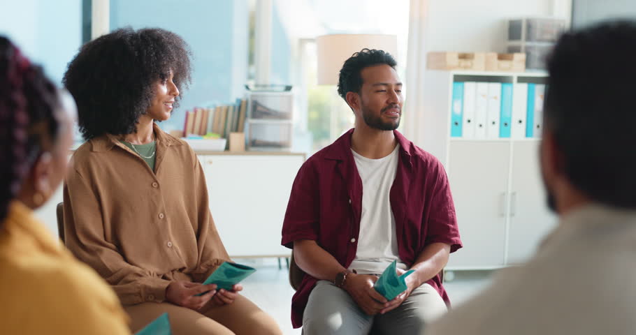 Happy people, discussion and convention with support group for counseling or rehabilitation. Man, speaker and talking with community for mental health, therapy session or team social in workplace