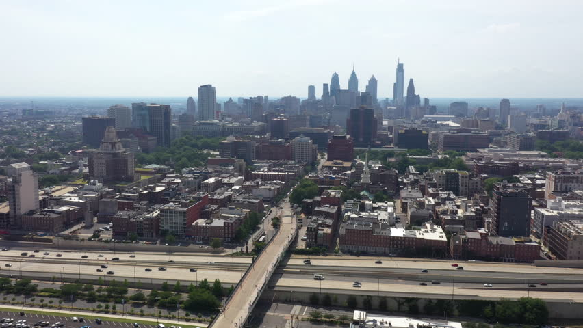Cars Driving In The Road With Downtown Philadelphia Skyline In The Distance In Philadelphia, Pennsylvania, USA.