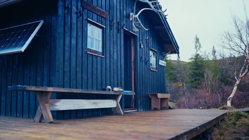 Alaskan Malamute Dog Outside A Cabin In Åfjord, Norway - Wide Shot