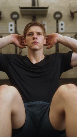 Man doing full crunch exercise in black shirt
