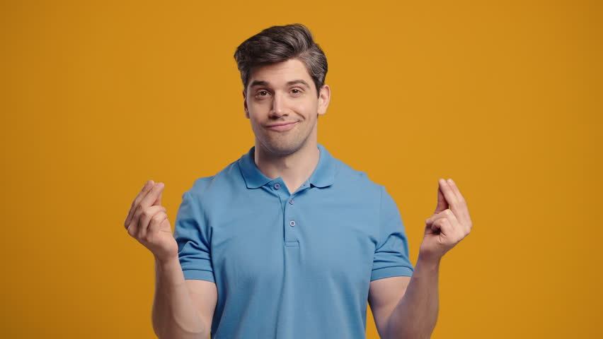 Smiling Man Asking Money Gesture On Yellow Studio Background. Smart Rich Dude