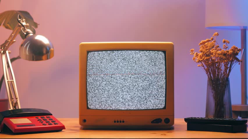 Retro TV, vintage television In a nostalgic setup, a retro TV displays grain on screen, scary halloween night device good for chroma key and green screen.