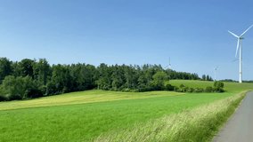 Pan over rural landscape wind turbines generating renewable electricity Germany - Powered by Shutterstock - Get 15% off with code: PIKWIZARD15