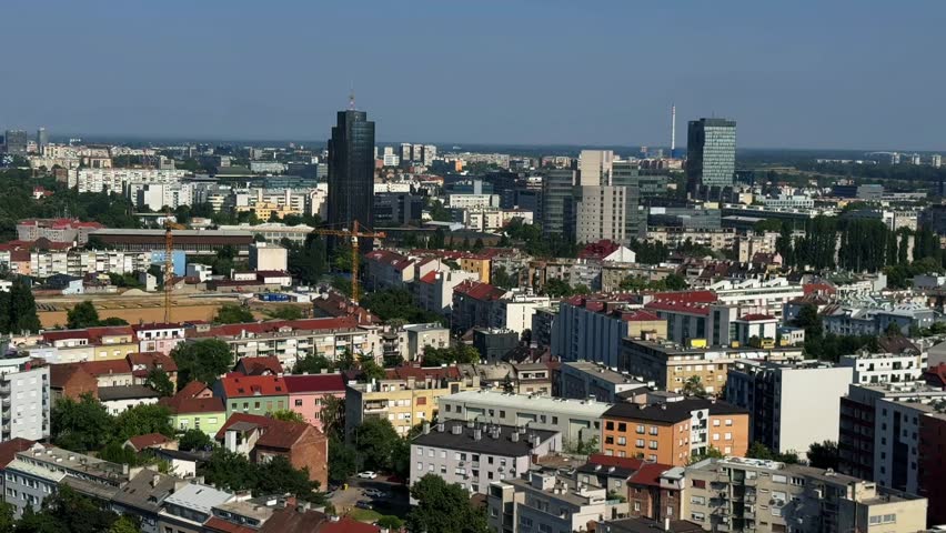 Cityscape panorama of Zagreb, Croatia, city center in summer sunny day in top view. Landscape video footage with office skyscrapers, historic buildings, streets, roads. Aerial perspective viewpoint.