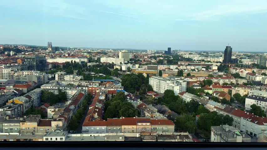 Cityscape video panorama of Zagreb, Croatia in summer day in top view. Landscape footage with skyscrapers and towers, residential buildings, historic sightseeing architecture in aerial viewpoint.