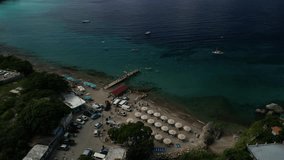 Aerial of Playa Piskado with boats, umbrellas, and people snorkeling in turquoise water.
Great for tourism, Caribbean promos, and vacation visuals - Powered by Shutterstock - Get 15% off with code: PIKWIZARD15