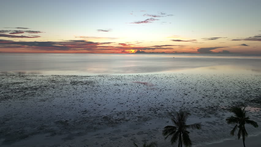 A remote, tropical island is surrounded by serene seas in Wakatobi National Park, Indonesia. This scenic area is a popular destination for divers and snorkelers due to high marine biodiversity.