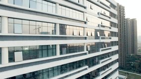 A modern building with glass windows reflects the urban landscape - Powered by Shutterstock - Get 15% off with code: PIKWIZARD15