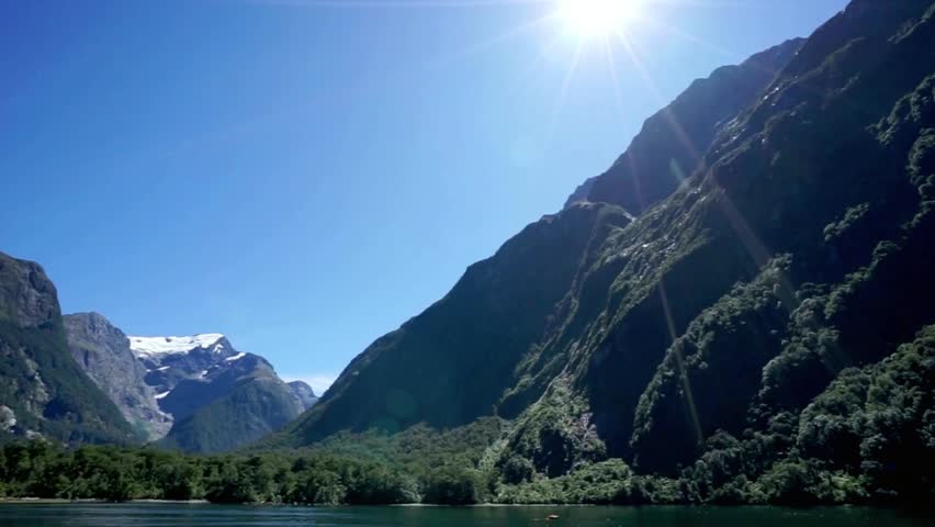 Majestic mountains meet the tranquil waters of fiordland, new zealand