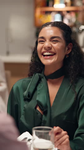 Happy, woman and listen on date at restaurant for discussion, romantic dinner and bonding together. Smile, couple and laugh for funny joke, anniversary occasion and fine dining at hospitality service