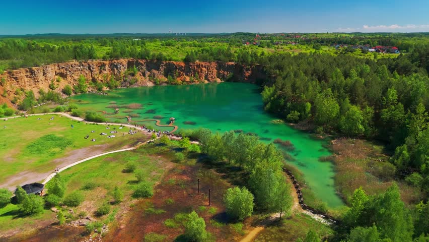 Aerial view of Park Grodek in Jaworzno, Southern Poland. Known as the Polish Maldives, the park features turquoise lakes in a former quarry, wooden walkways, and lush natural surroundings.