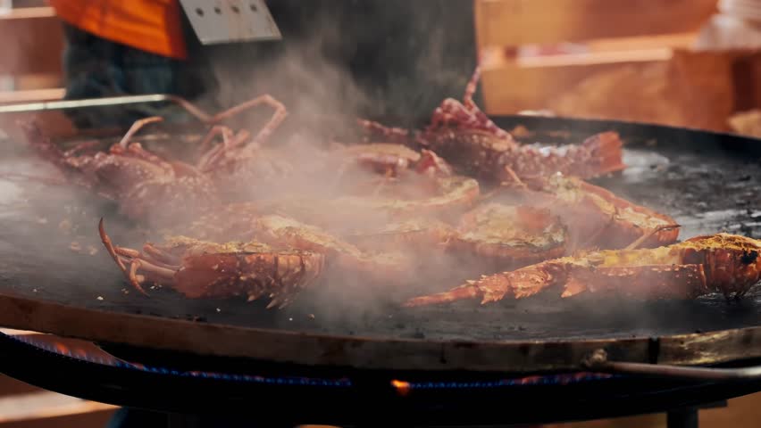 Close-up of grilled fresh spiny lobsters served at the traditional Lobster Festival in A Guarda, Galicia, Spain. Local seafood celebration on the Atlantic Ocean coast of Northern Spain.