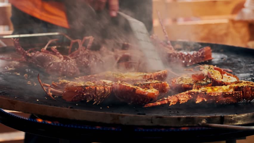 Close-up of grilled fresh spiny lobsters served at the traditional Lobster Festival in A Guarda, Galicia, Spain. Local seafood celebration on the Atlantic Ocean coast of Northern Spain.