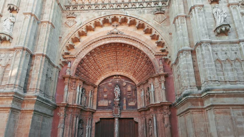 Beautiful facade of the Cathedral of Santa Maria of Palma in Palma de Mallorca, Balearic Islands, Spain. Impressive Gothic architecture with intricate stone carvings, a landmark of Majorca island