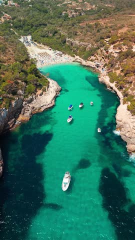 Aerial top down view of the Cala Llombards beach in Mallorca, Balearic Islands, Spain. Stunning Mediterranean Sea coast with turquoise water sea bay and white sand beach. Mallorca travel destinations