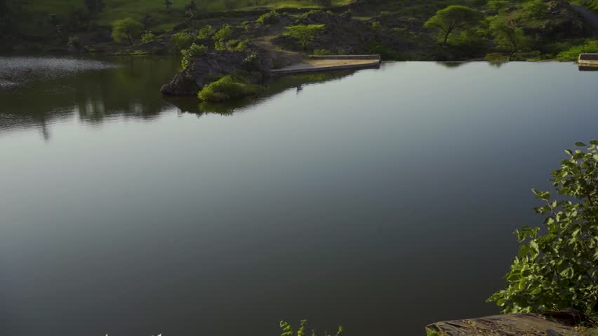 Spectacular view of Alsigarh Lake in Rayta Hills, with a beautiful reflection in the water. Udaipur, Rajasthan, India.