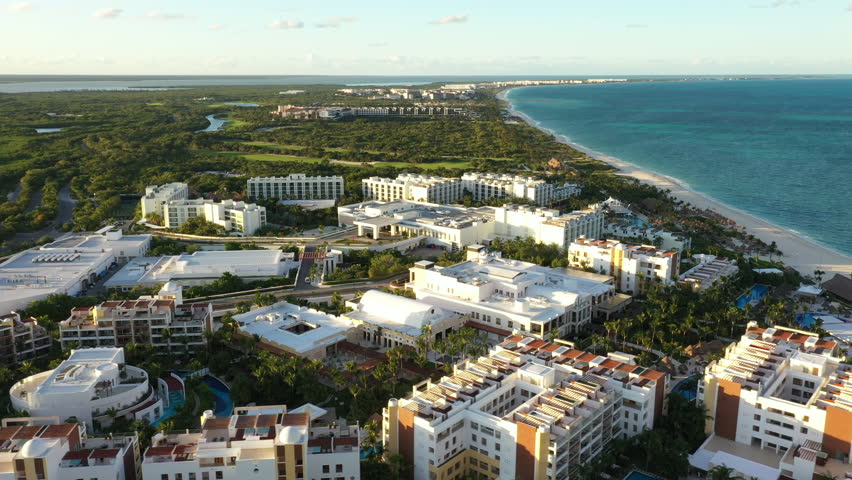 Beachfront All-inclusive Resort Along The Caribbean Sea With Palm Trees In Cancun, Quintana Roo, Mexico. - aerial shot