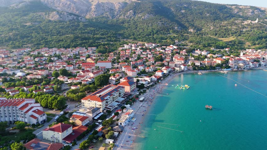 Baska Beach and Coastline With Clear Turquoise Water, Marina Boats, City Street, Sunny Summer Sunset Aerial View on Krk Island, Croatia Adriatic Sea, Vela Plaza Beach, Mountains and Campsite Cityscape
