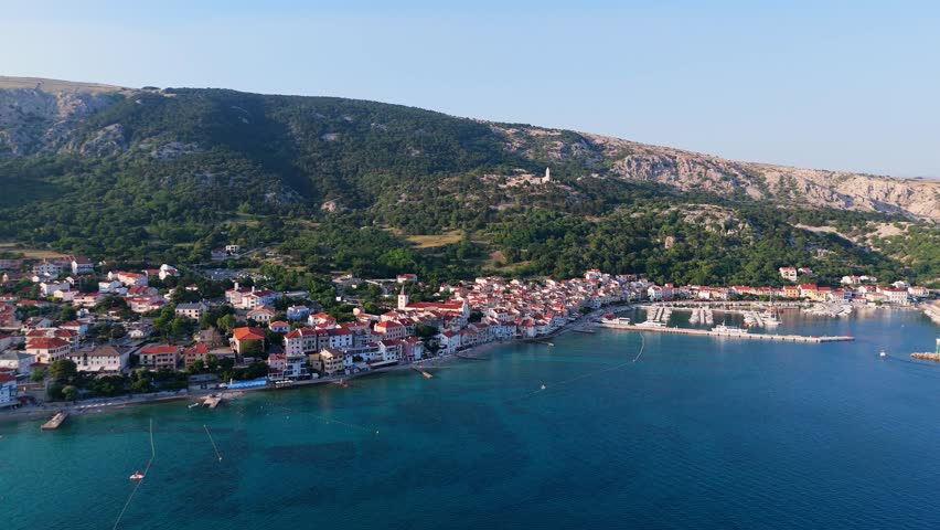 Baska Beach and Coastline With Clear Turquoise Water, Marina Boats, City Street, Sunny Summer Sunset Aerial View on Krk Island, Croatia Adriatic Sea, Vela Plaza Beach, Mountains and Campsite Cityscape