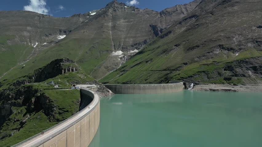 Stunning aerial view of the Stausee Mooserboden reservoir nestled among snow-dusted peaks in the Austrian Alps near Kaprun