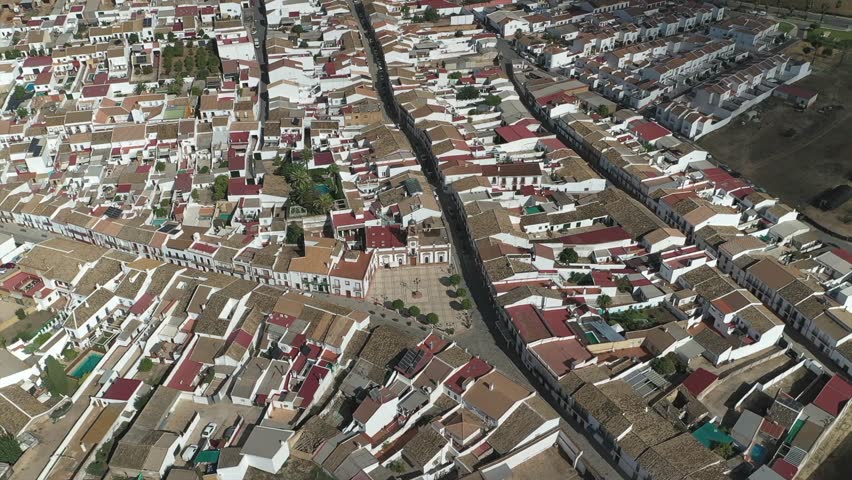 Chucena town hall and square, municipal building in Andalusia, Spain. Aerial descending, drone approach