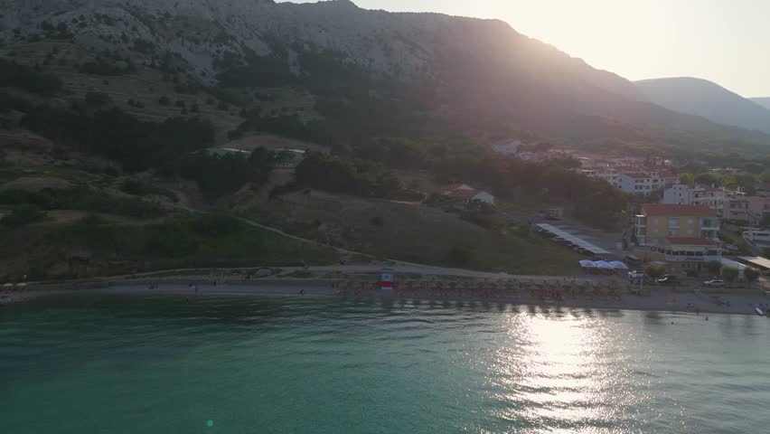 Hiking Trail Leading From the Beach in Baska to the Bag Mountain, City Panorama Seen From Above, Azure Water in the Bay by the Beach in Baska, on Krk Island, Croatia. Mediterranean Summer at Sunset