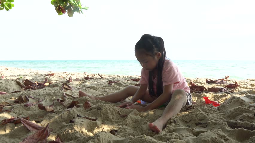 Carefree children play and splash on a sunlit sandy beach during the summer holiday, capturing joyful freedom, seaside fun, and warm vacation vibes.