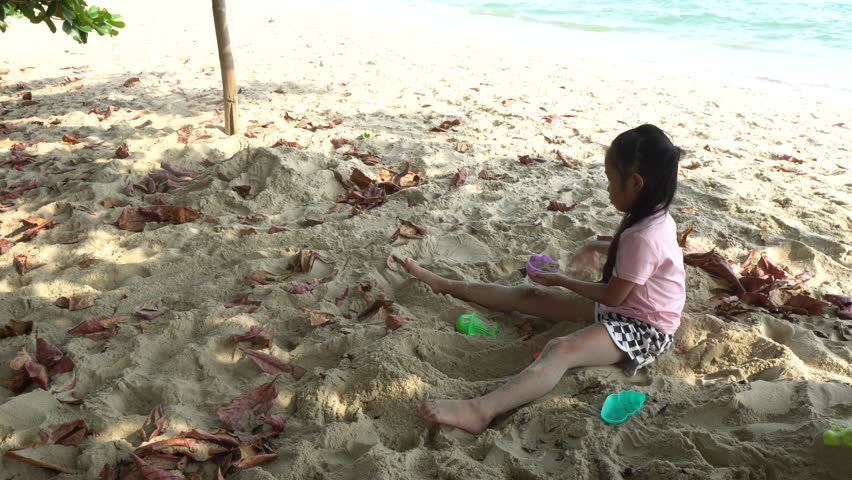 Carefree children play and splash on a sunlit sandy beach during the summer holiday, capturing joyful freedom, seaside fun, and warm vacation vibes.