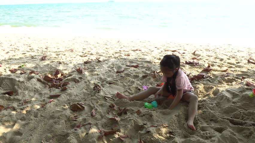 Carefree children play and splash on a sunlit sandy beach during the summer holiday, capturing joyful freedom, seaside fun, and warm vacation vibes.