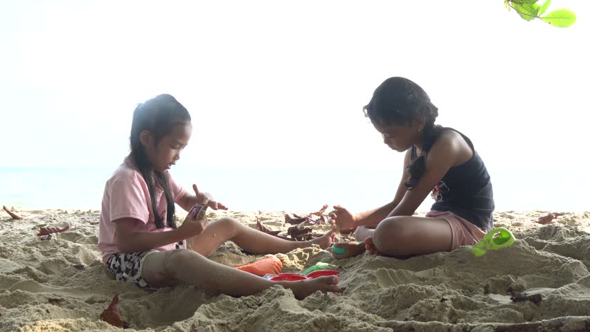 Carefree children play and splash on a sunlit sandy beach during the summer holiday, capturing joyful freedom, seaside fun, and warm vacation vibes.