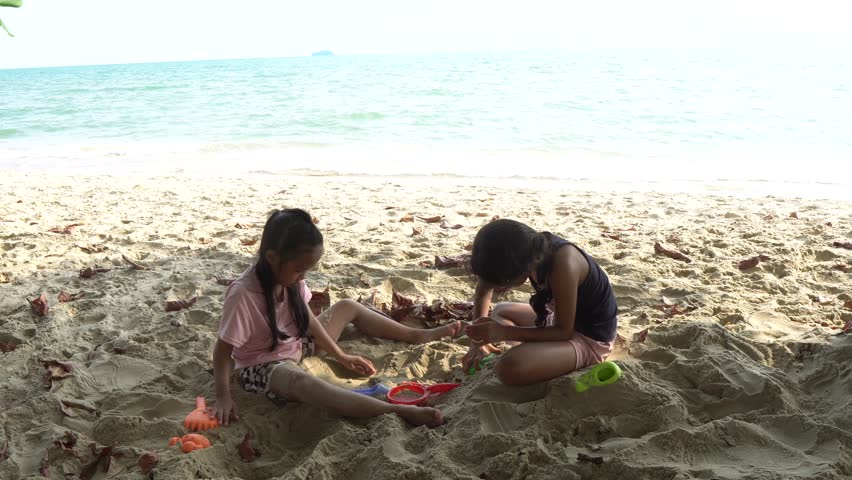 Carefree children play and splash on a sunlit sandy beach during the summer holiday, capturing joyful freedom, seaside fun, and warm vacation vibes.