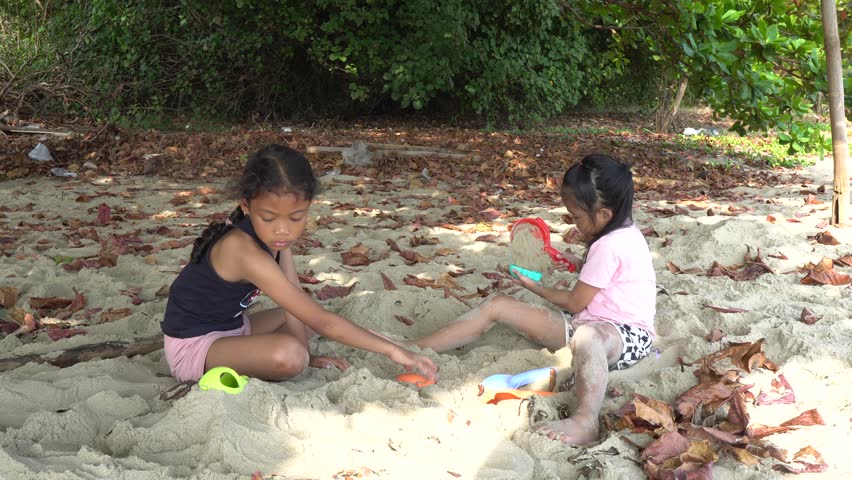 Carefree children play and splash on a sunlit sandy beach during the summer holiday, capturing joyful freedom, seaside fun, and warm vacation vibes.