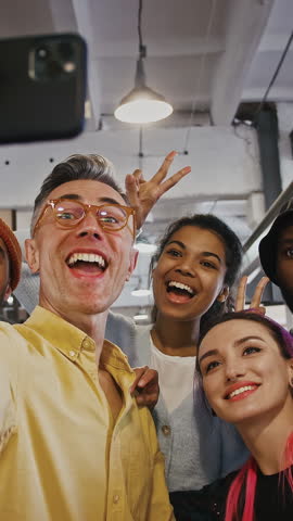 Cheerful business team taking selfie, posing for photo during break in office, posing to camera, tracking shot