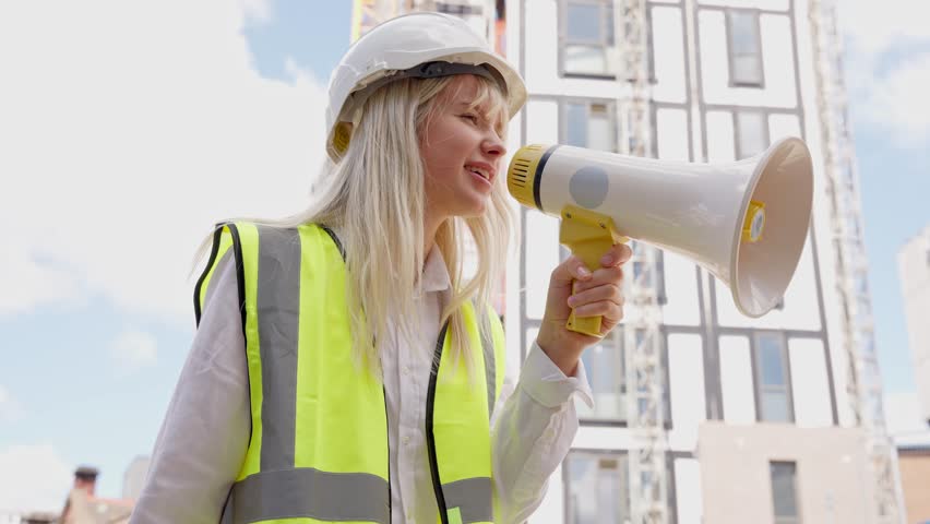 Construction worker leads project team with megaphone at urban site during sunny morning hours - Powered by Shutterstock - Get 15% off with code: PIKWIZARD15
