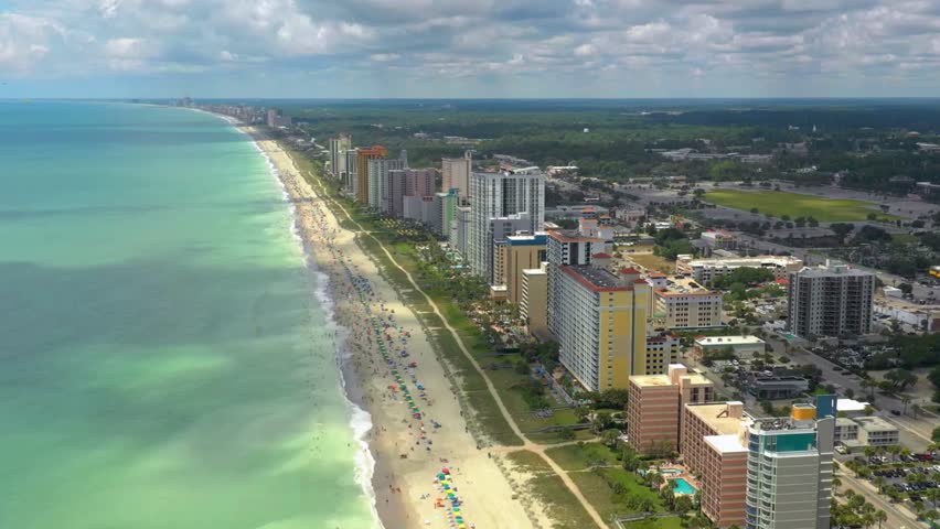 Aerial Drone Views of Myrtle Beach, South Carolina – Crescent Shoreline, Oceanfront Resorts, Urban Coastline, and Sandy Beaches Along the Iconic Atlantic Coast Vacation Destination. 