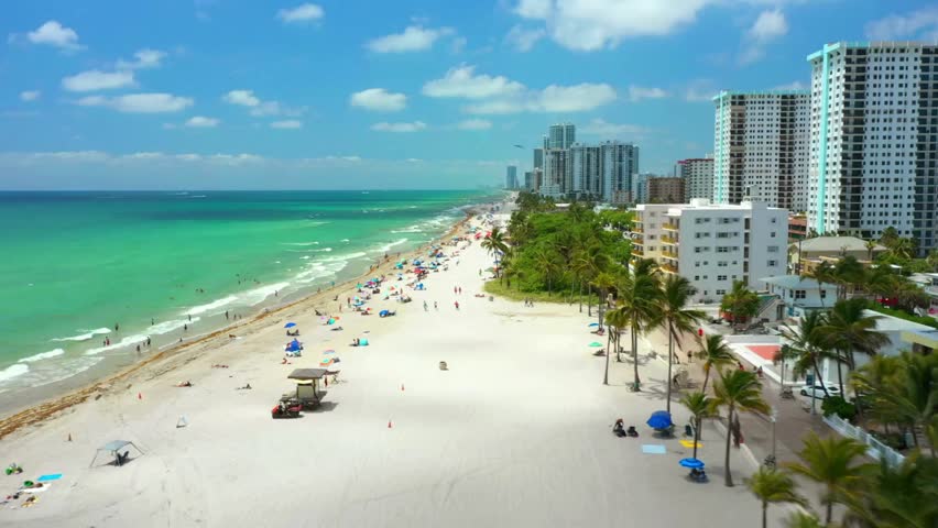 Low Aerial Drone Footage of Hollywood Beach Florida, Ocean Waves, Tourists, and Scenic Coastal Skyline on Sunny Day – Memorial Day Weekend, Broward County Travel Destination in Summer.          