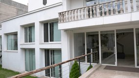 Modern garden with manicured lawn, architectural canopy structure in black, surrounding conifer trees, a white concrete planter, and layered landscape design. The scene evokes  - Powered by Shutterstock - Get 15% off with code: PIKWIZARD15